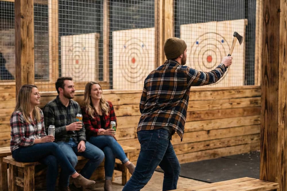 A person sitting and preparing to throw an axe